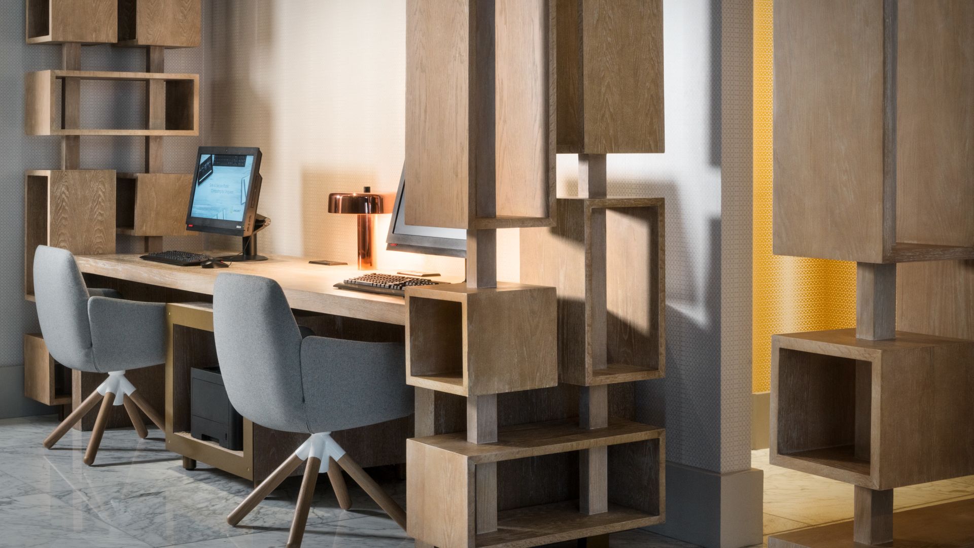A Room With A Desk And Chairs