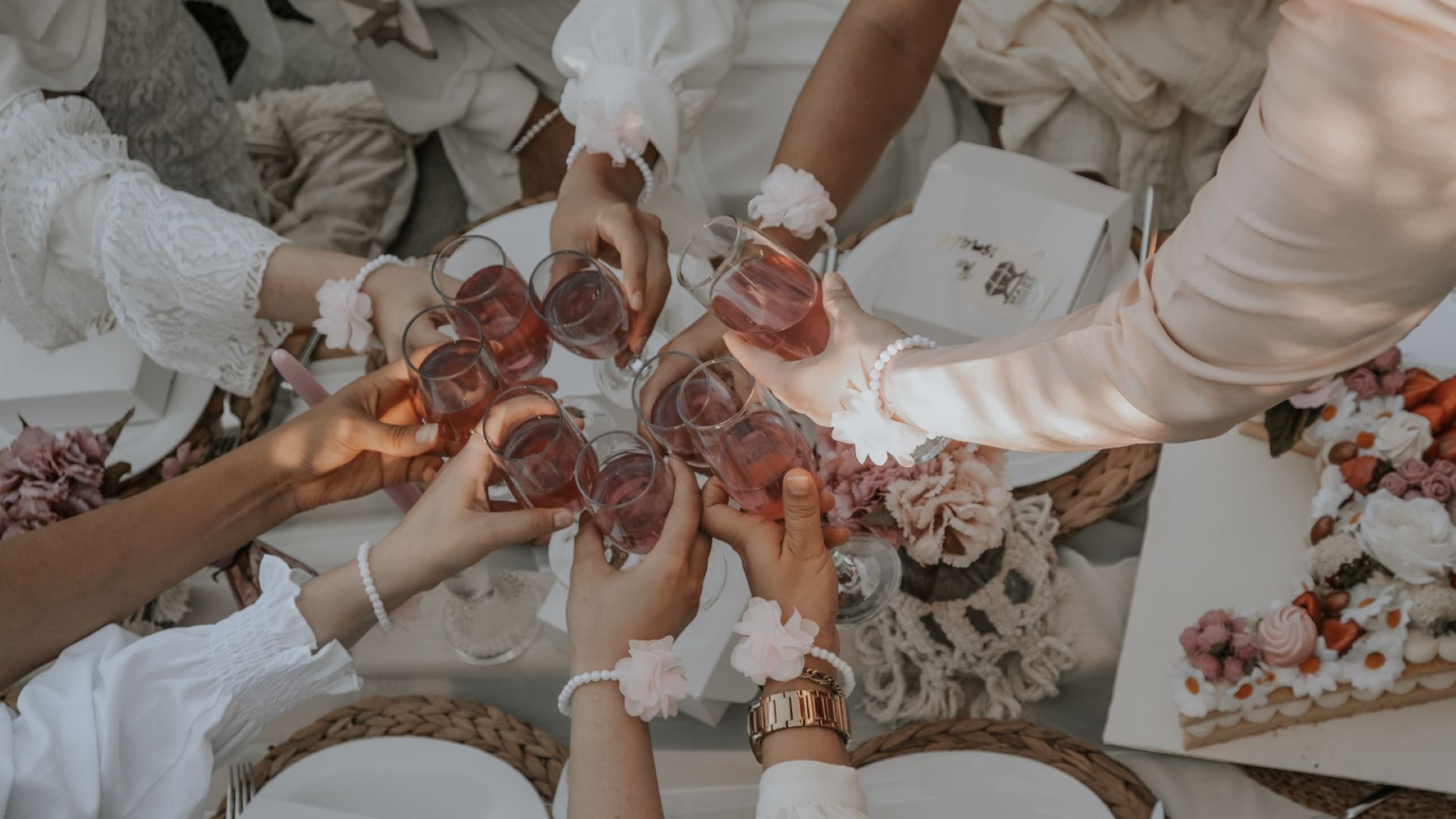 A Group Of People Holding Wine Glasses