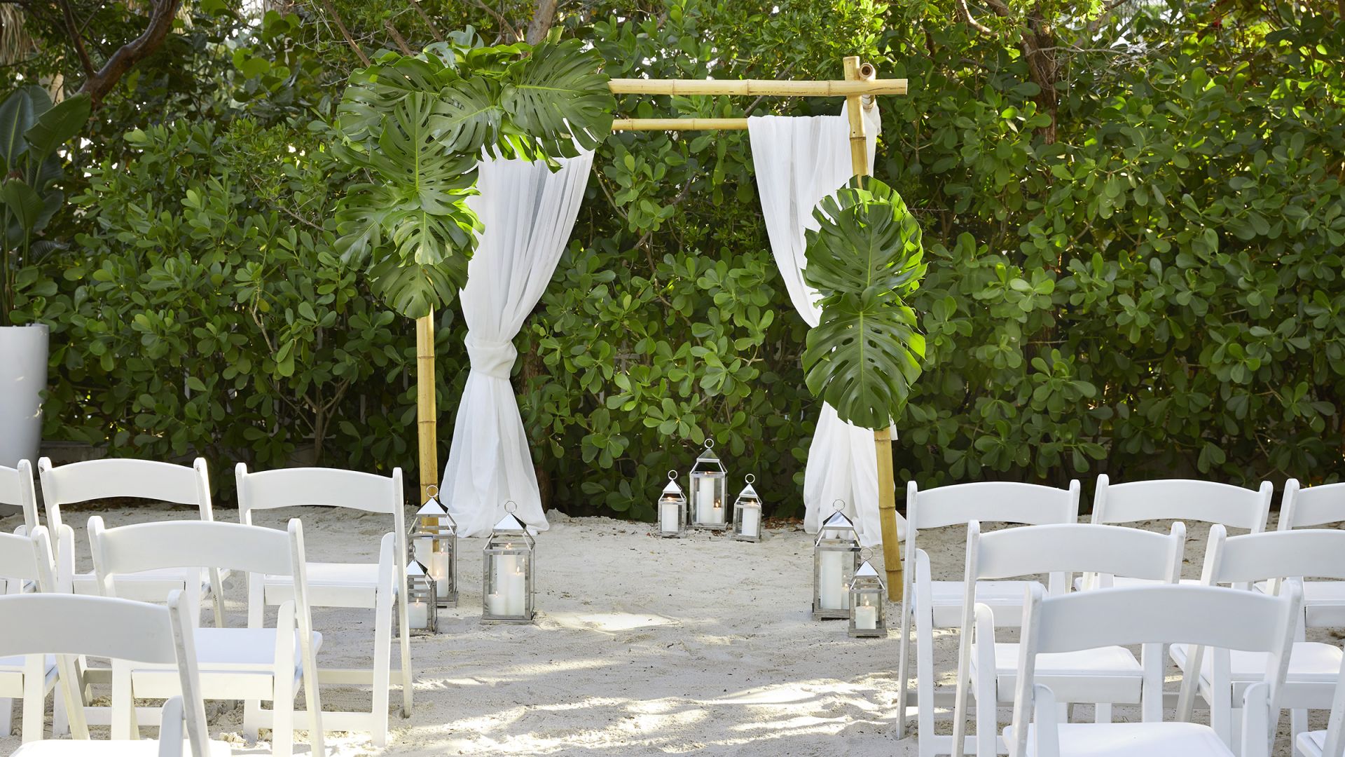 A Group Of White Chairs And Tables