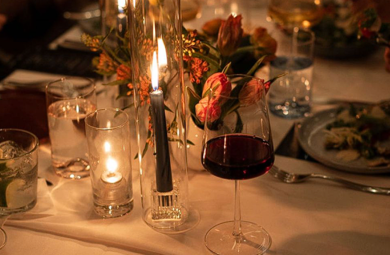 A Table With Wine Glasses And Candles